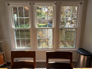 An interior view of three newly installed windows looking out to a backyard by NC Siding and Windows in Raleigh, NC
