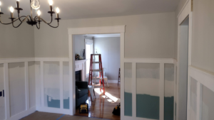 An interior room with newly installed wainscoting and paint samples by Volunteer Building Services in Knoxville, TN.