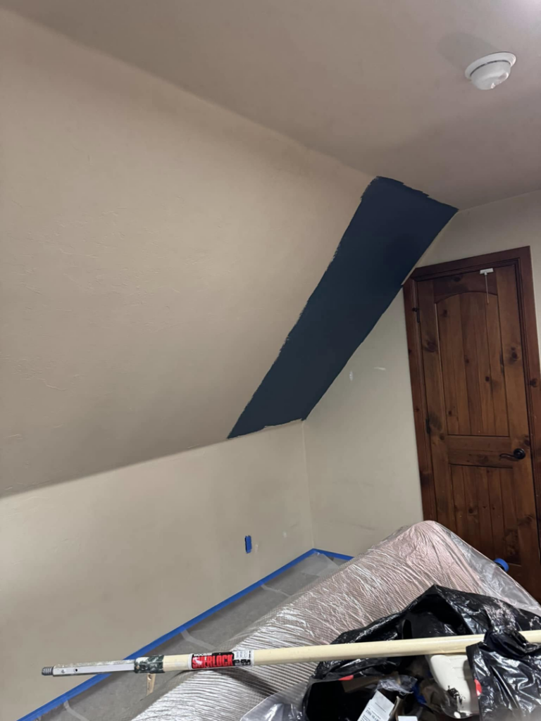 An interior wall and angled ceiling painting project in progress, handled by Sanders Construction & Handyman Services, LLC in Oklahoma City, OK.