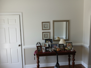 An interior wall with a door, showcasing new crown molding and baseboards installed by Quiros Remodeling in Greenville, SC.