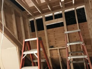 Interior wooden framing for a new wall or room addition, showing ongoing construction by Advanced Seamless Gutters, Inc. in Chicopee, MA.