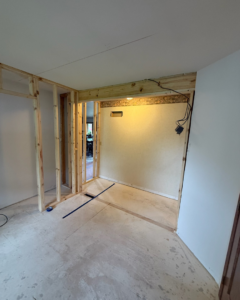 Interior room showing new wooden wall framing during a construction or renovation project by Fix Fast Flip, LLC in Plainfield, IL.