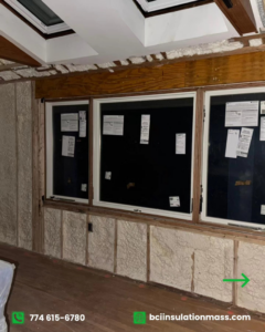 Interior wall insulation with spray foam around multiple windows in a room by BCI Insulation in Byron, GA