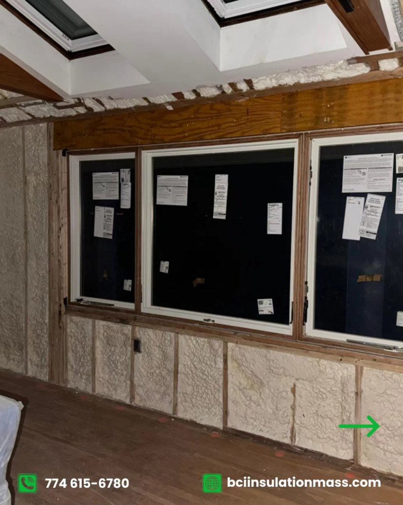 Interior wall insulation with spray foam around multiple windows in a room by BCI Insulation in Byron, GA