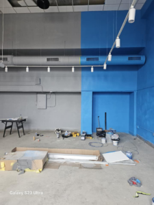 Interior wall painting in progress with blue and grey sections by Logical Drywall and Painting in St. Louis, MO.