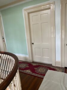 Interior wall painting in progress, showing a partially painted green wall by S-G General Contracting LLC in Philadelphia, PA.