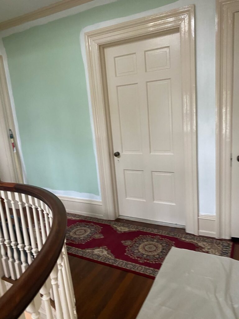 Interior wall painting in progress, showing a partially painted green wall by S-G General Contracting LLC in Philadelphia, PA.