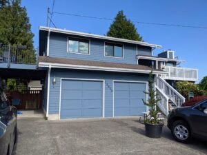 A professional painter applying paint to an interior wall, a service offered by Brush N' Roll Painting Co. in Federal Way, WA.