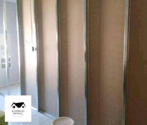 Interior wall panel installation, a type of handyman service offered by Waterbury Drywall in Waterbury, CT.