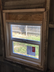 Interior view of a new window installation with OSB board framing by Choice Contractors LLC in Fort Wayne, IN.