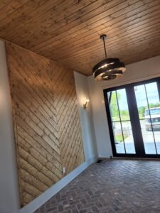 An interior room featuring a stylish wooden chevron accent wall and plank ceiling installed by Richwood Remodeling & Outdoor in Nashville, TN.