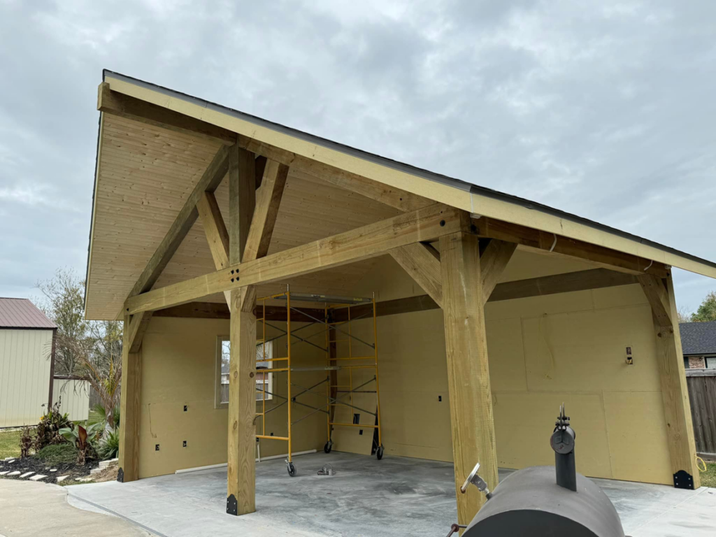 Interior view of wood beam construction for an outdoor structure by Royal Construction & Remodeling, Inc. in Lake Charles, LA.