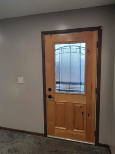 A newly installed interior wooden door with decorative glass by The Handyman Gabriel in Madison, WI