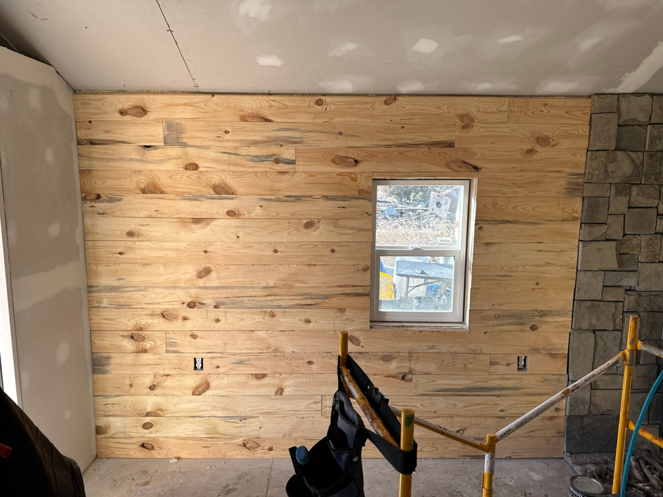 Interior wood paneling being installed on a wall during a renovation by Devil Dog Services LLC in Billings, MT.