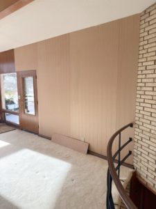 Interior room with wood wall paneling, a project completed by Bespoke Finish, a handyman in Minneapolis, MN.
