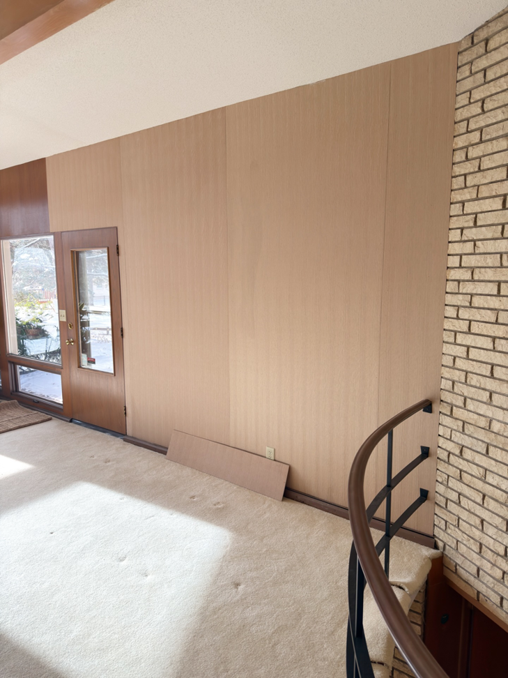 Interior room with wood wall paneling, a project completed by Bespoke Finish, a handyman in Minneapolis, MN.