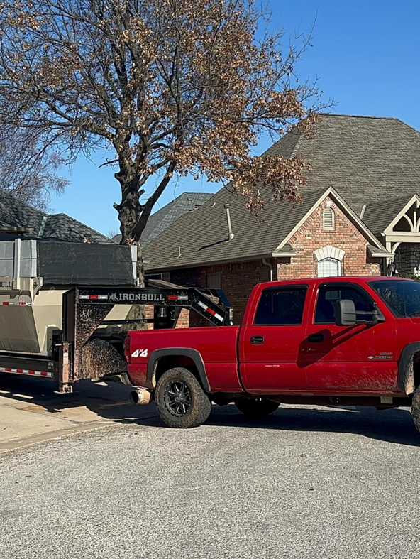 Ricky's Dump Truck with an Ironbull dump trailer parked on a residential street in Oklahoma City, OK, for a job.