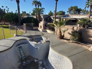 Concrete pool deck installation around an irregularly shaped pool by Martin Jr's concrete in Surprise, AZ