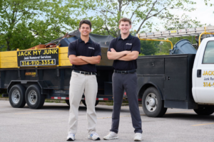 Two Jack My Junk employees standing proudly with their loaded junk removal truck and trailer in St. Charles, MO.