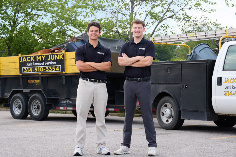 Two Jack My Junk employees standing proudly with their loaded junk removal truck and trailer in St. Charles, MO.