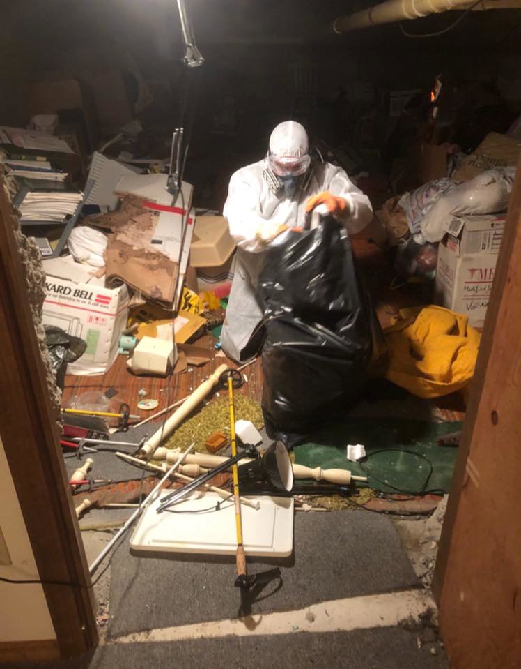 A JDog Junk Removal & Hauling Capital Region NY crew member performing a hoarder cleanout in Schenectady, NY.