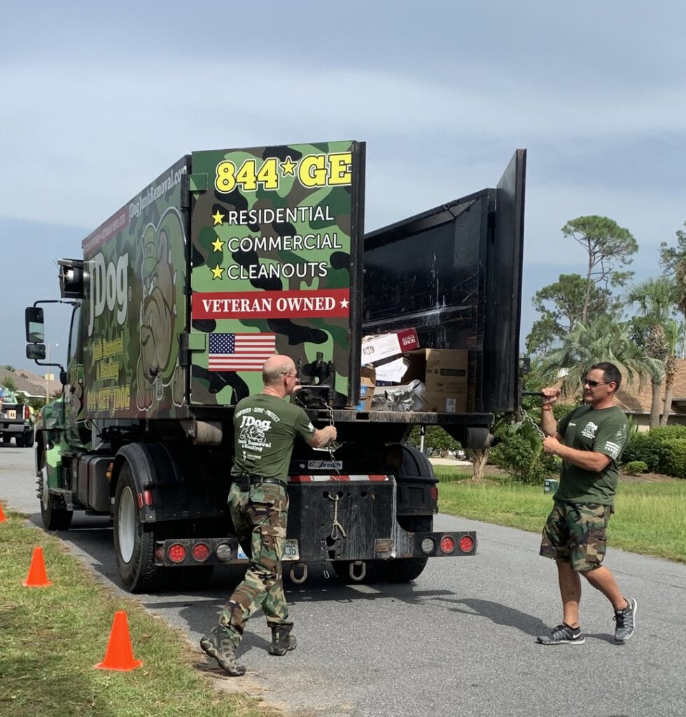 JDog Junk Removal & Hauling Savannah/HHI team members loading various items of junk into a dumpster truck.