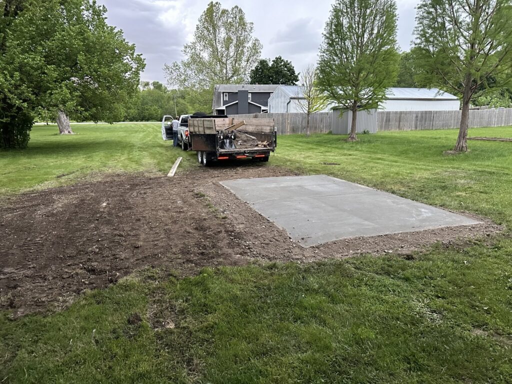 A newly installed concrete slab for a shed foundation or patio by JOCO Services in Council Bluffs, IA.