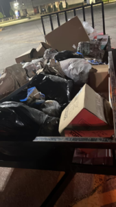 Various junk items, including trash bags and boxes, loaded into a trailer for removal by Resilient Trash and Cleaning LLC in New Orleans, LA.