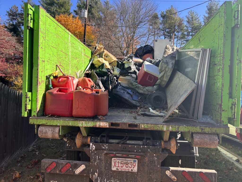 The back of a Junkluggers truck filled with various items of junk after a successful removal job in Hicksville, NY.