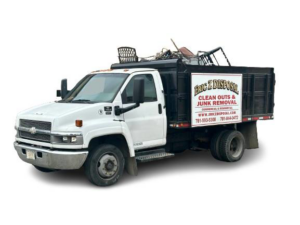 A junk hauling truck filled with debris and old furniture, provided by Robert Z Disposal in Lynn, MA.