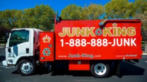 A red Junk King junk removal truck parked and ready for service in Greensboro, NC.