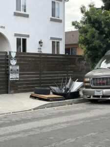 A pile of miscellaneous junk on a sidewalk, ready for pickup by West LA Hauling in Los Angeles, CA.