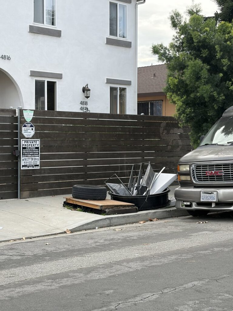 A pile of miscellaneous junk on a sidewalk, ready for pickup by West LA Hauling in Los Angeles, CA.