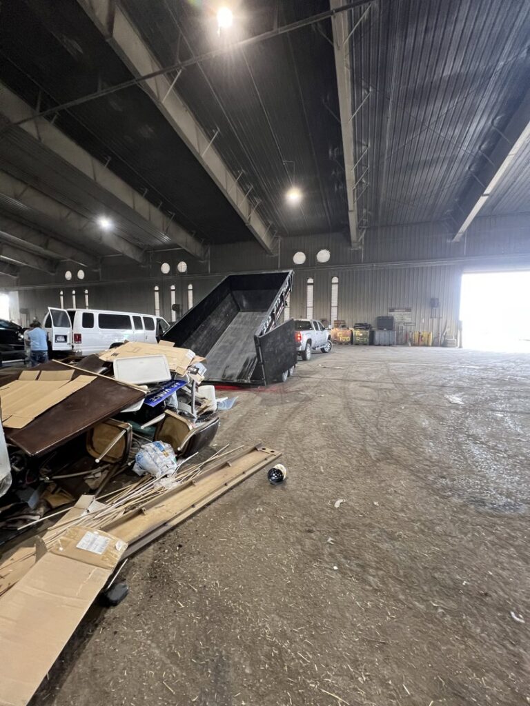 A large pile of various junk and debris inside a warehouse, handled by DumpsterDash-LLC in Ogden, UT.