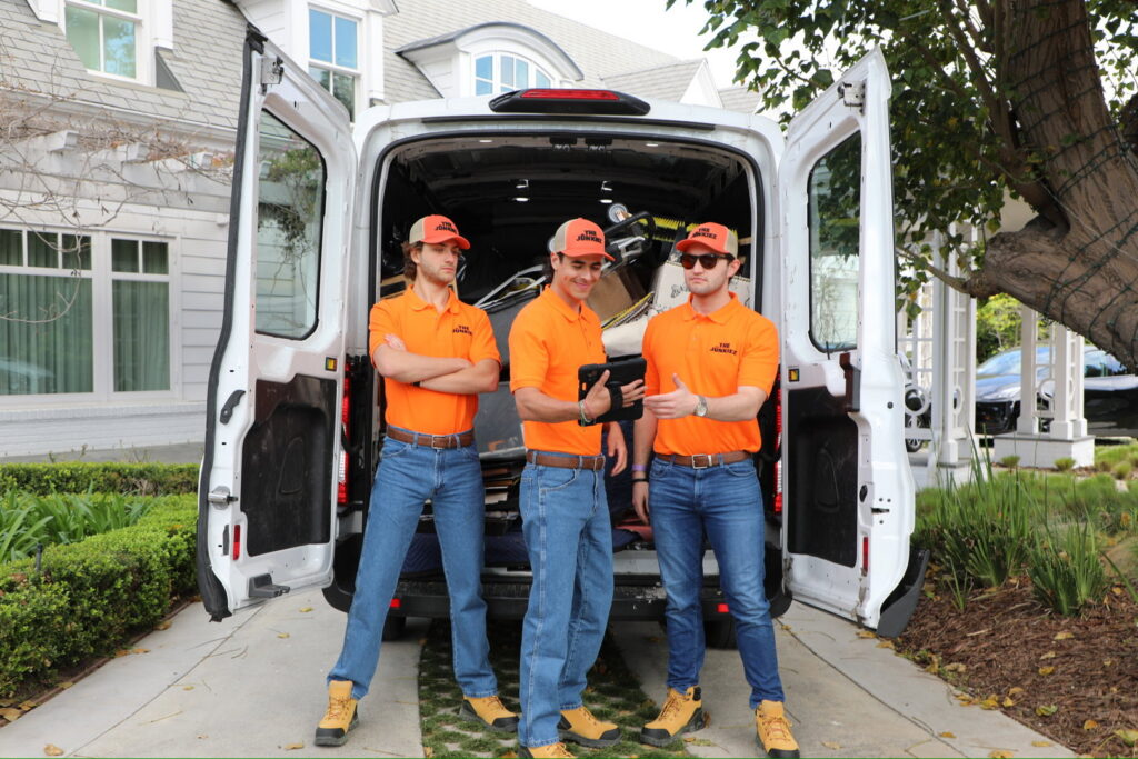 The Junkiez Junk Removal crew standing proudly with their loaded van after a job in Los Angeles, CA.