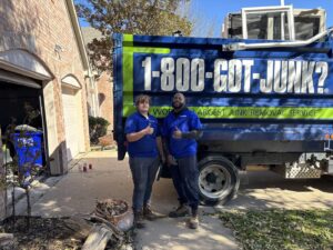 Two 1-800-GOT-JUNK? crew members with their truck and debris from a junk removal job in Bronx, NY
