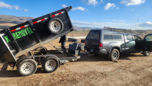 A branded junk removal dump trailer being unloaded by Dunk The Junk in Carson City, NV.