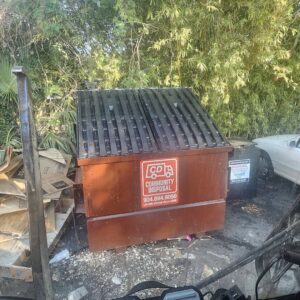A brown dumpster from Community Disposal filled with junk and cardboard, ready for removal in Jacksonville, FL.
