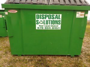 A large green junk removal dumpster from Disposal Solutions, your local choice in Jonesboro, AR.