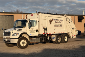 A white junk removal garbage truck from American Eagle Waste parked in Saint Louis, MO, ready for service.