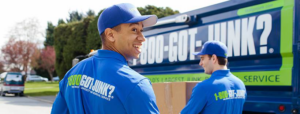 Two 1-800-GOT-JUNK? team members carrying a box to their truck for junk removal in Charleston, SC.
