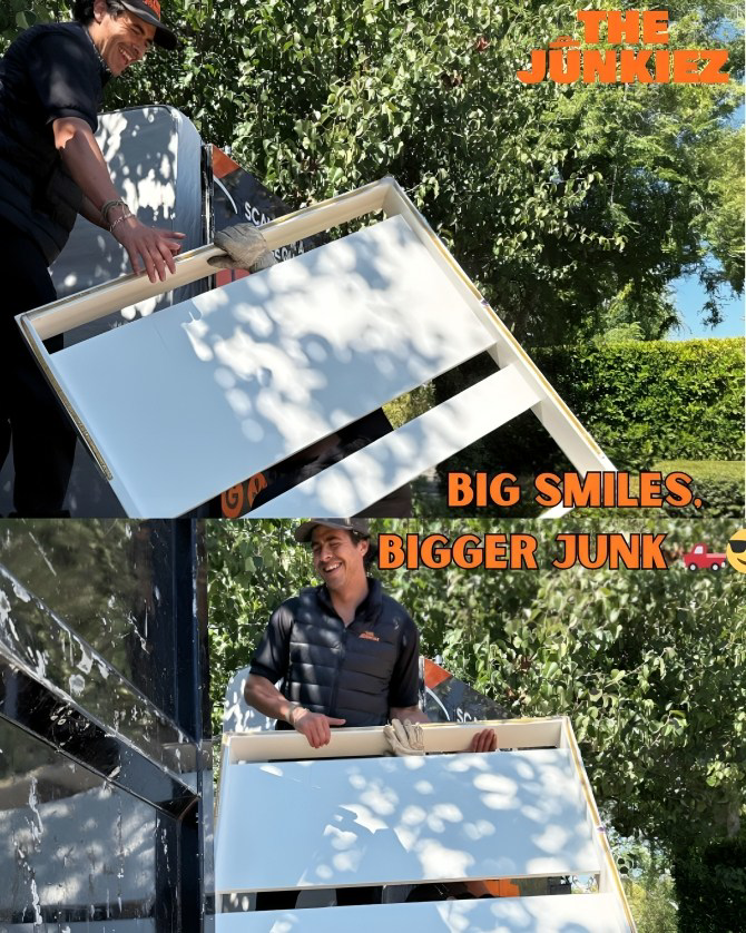 A team member from The Junkiez Junk Removal loading a large white panel into a truck in Los Angeles, CA.