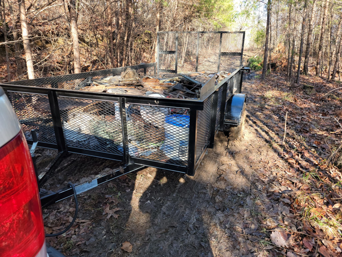 A trailer filled with various debris and junk items, ready for removal by Haulin' Junk Chattanooga in Chattanooga, TN.