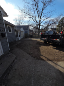 A junk removal trailer filled with debris, parked at a job site by Property Solutions & Junk Removal LLC in East Peoria, IL.