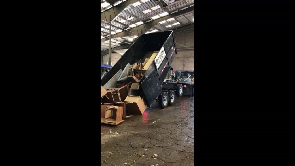 A Haul It All Services junk removal trailer dumping its contents at a landfill in Albuquerque, NM
