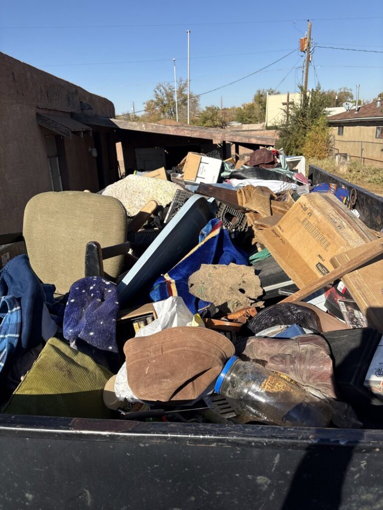 A Haul It All Services junk removal trailer dumping its contents at a transfer station in Albuquerque, NM