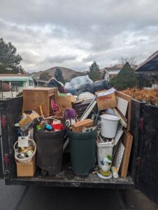 A Junk Free Solutions trailer filled with furniture, bags, and boxes after a junk removal job in Reno, NV.