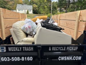 A junk removal trailer full of household debris and furniture from Champion Waste Services in Londonderry, NH.