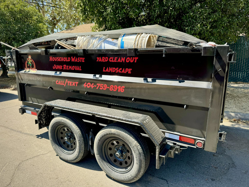 A Wasted Junk Removal trailer full of household waste and debris after a junk removal job in Corona, CA.