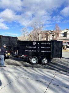 A Junk Free Solutions team member preparing a large junk removal trailer for a job in Reno, NV.